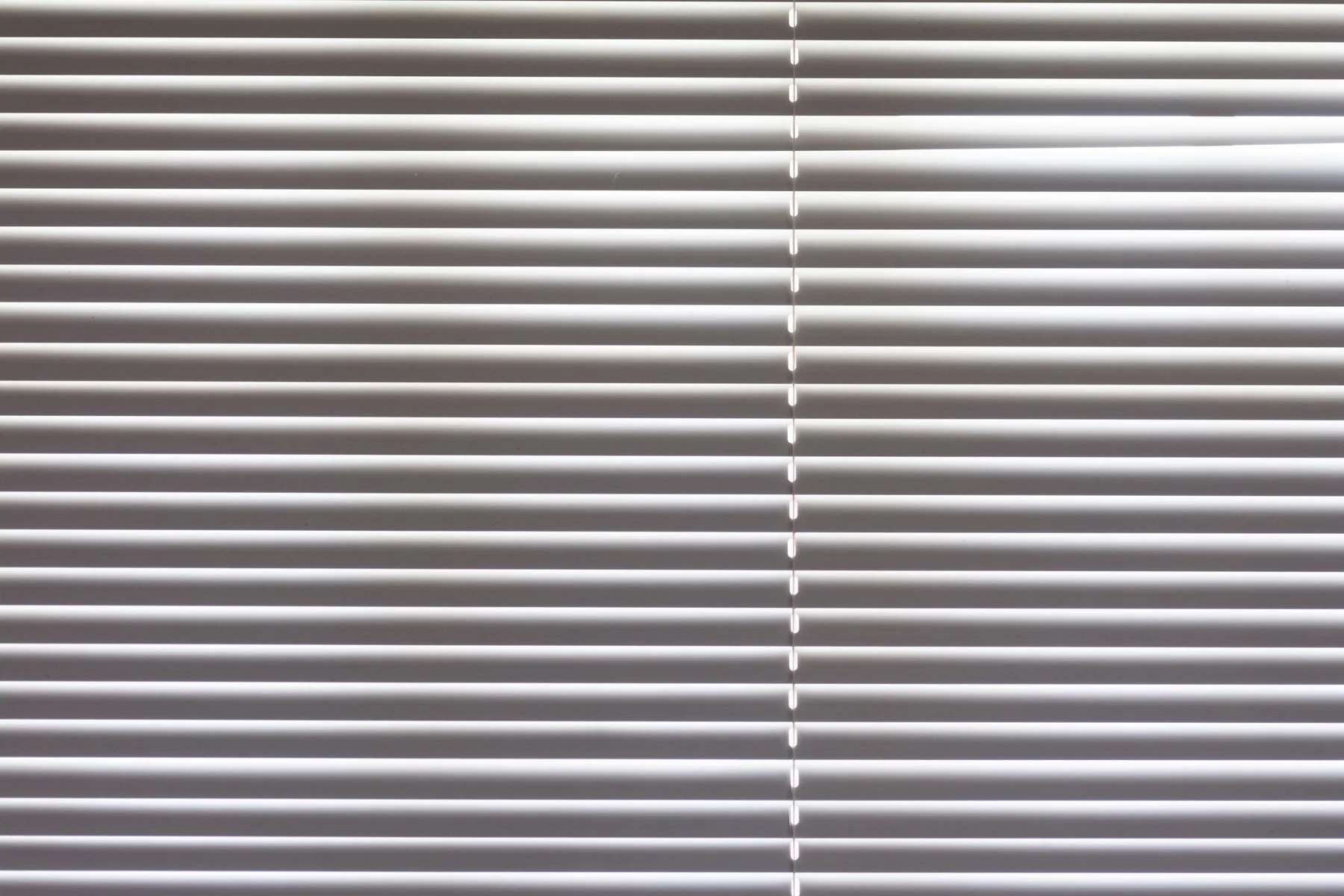 Close view of white horizontal blinds and their clean lines