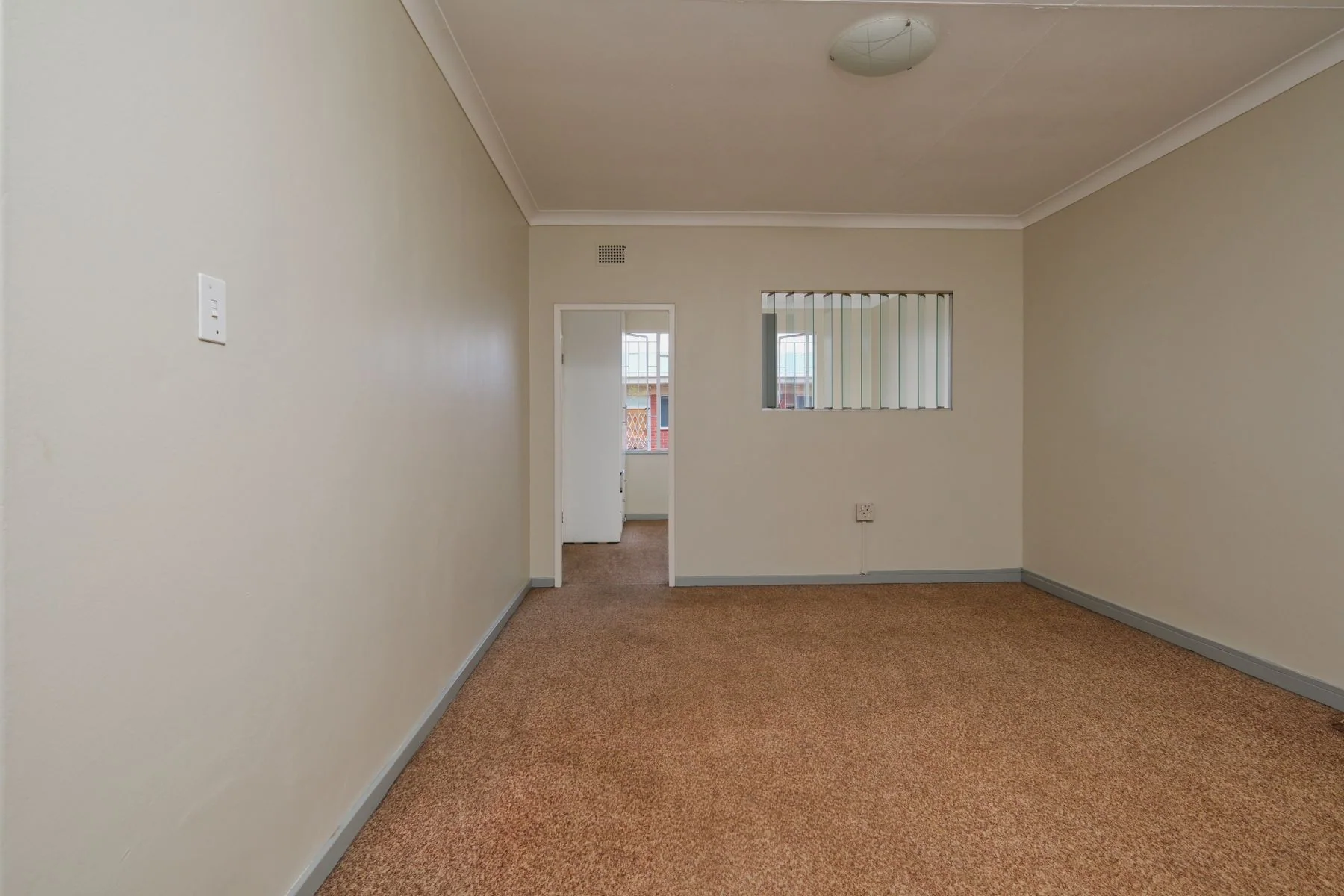 Muted fitted carpet across a neutral room